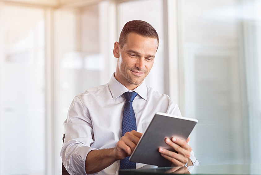 Businessman using a tablet at his desk