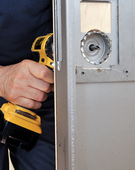 man repairing a metal door Repairs and Maintenance Service